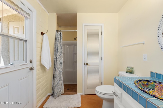 bathroom with toilet, vanity, and a shower with curtain