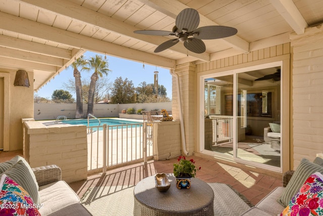 view of patio with a fenced in pool and ceiling fan