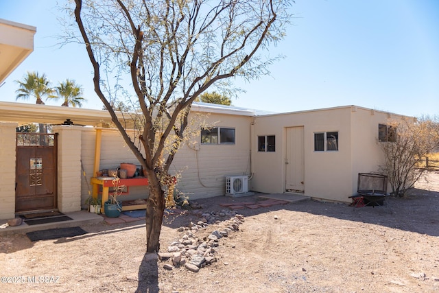 back of property featuring ac unit