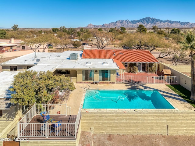 view of swimming pool featuring a mountain view and a patio area