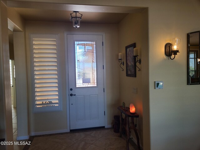 foyer with dark tile patterned floors