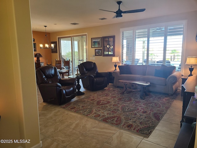 living room with ceiling fan with notable chandelier