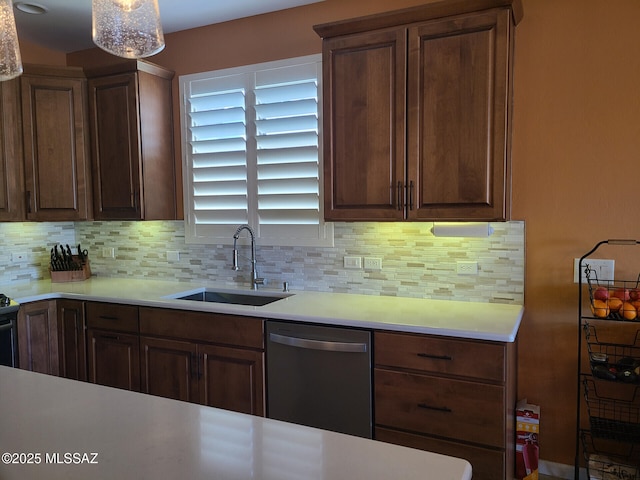 kitchen with stainless steel dishwasher, sink, and backsplash