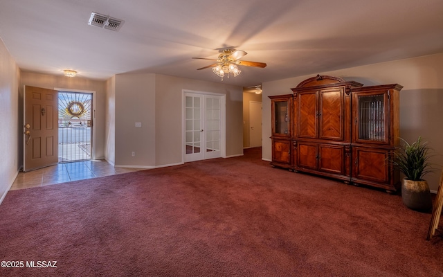 8497 E Hodgman Pl, Tucson, AZ 85747 - unfurnished living room featuring a ceiling fan, french doors, baseboards, carpet floors, and tile patterned flooring