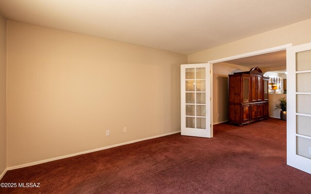 8497 E Hodgman Pl, Tucson, AZ 85747 - unfurnished room featuring french doors, dark colored carpet, and baseboards