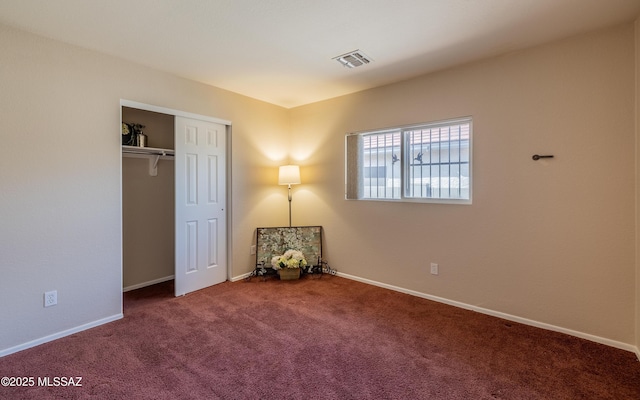8497 E Hodgman Pl, Tucson, AZ 85747 - unfurnished bedroom featuring carpet floors, baseboards, and a closet