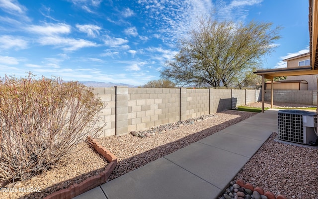 8497 E Hodgman Pl, Tucson, AZ 85747 - fenced backyard featuring cooling unit, a patio, and a mountain view