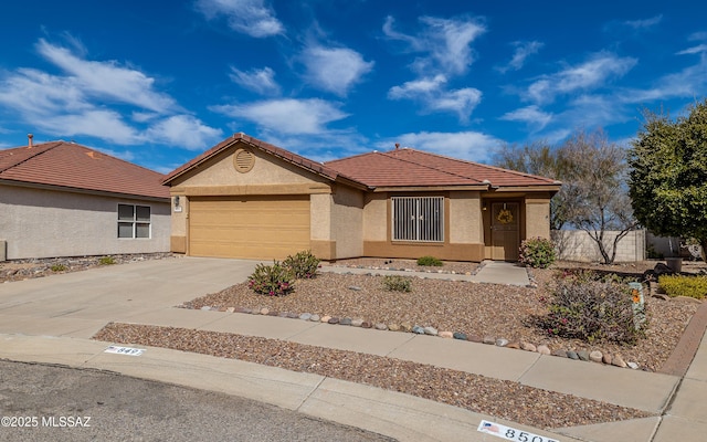 8497 E Hodgman Pl, Tucson, AZ 85747 - single story home with an attached garage, stucco siding, driveway, and a tile roof