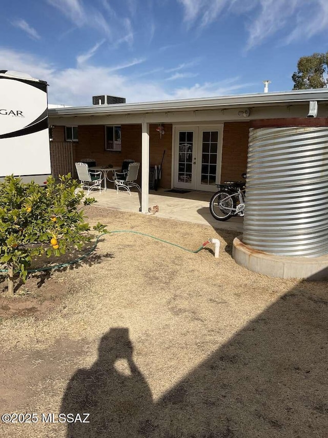 rear view of property with french doors and a patio area