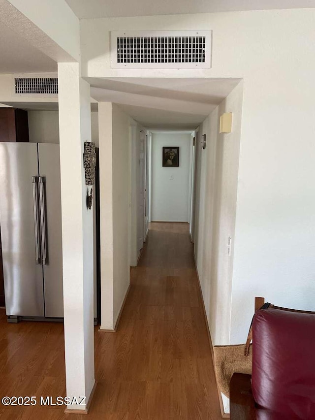 corridor with hardwood / wood-style flooring