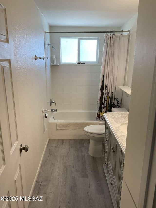 full bathroom featuring vanity, hardwood / wood-style flooring, toilet, and shower / tub combo with curtain