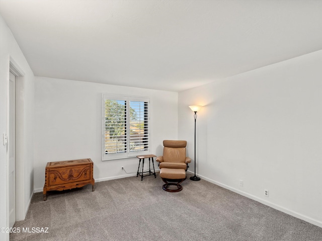 sitting room featuring carpet floors and baseboards