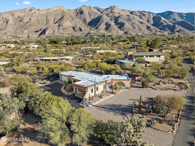 birds eye view of property with a mountain view