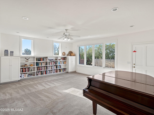 living area featuring recessed lighting and light colored carpet