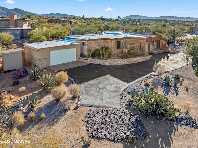 view of front facade featuring a garage and a mountain view