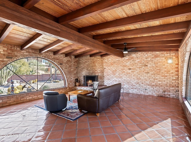 view of patio / terrace featuring ceiling fan and a brick fireplace