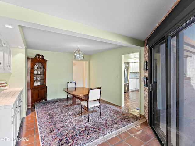 tiled dining area with recessed lighting and beamed ceiling