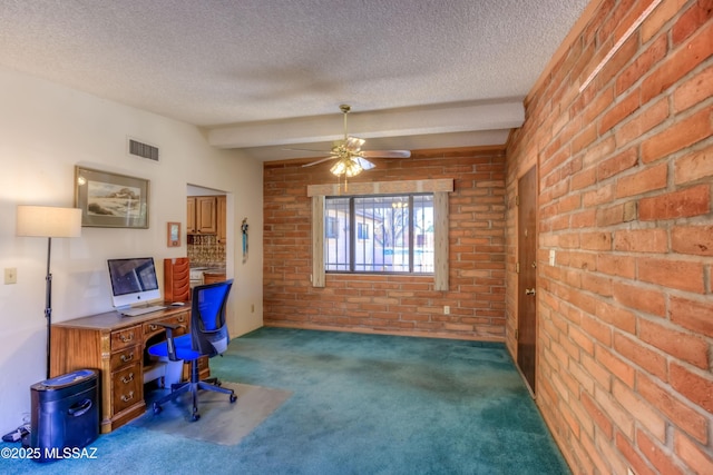 carpeted home office featuring a textured ceiling, brick wall, visible vents, and a ceiling fan