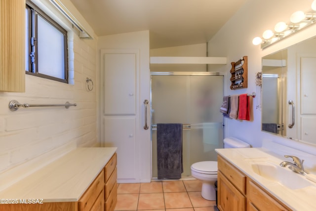 bathroom with a stall shower, tile patterned flooring, vanity, and toilet