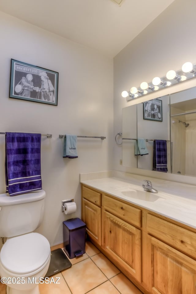 full bath with toilet, tile patterned flooring, and vanity