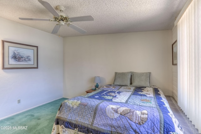 bedroom with carpet, ceiling fan, and a textured ceiling