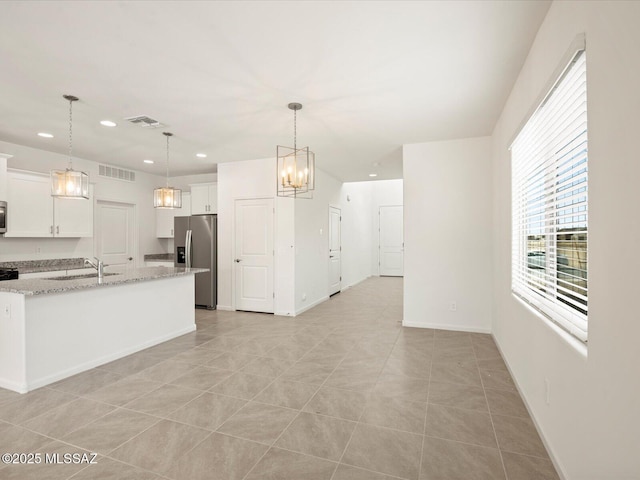 kitchen featuring baseboards, visible vents, recessed lighting, stainless steel appliances, and white cabinets