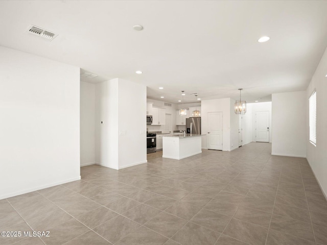 unfurnished living room featuring a notable chandelier, visible vents, recessed lighting, and baseboards