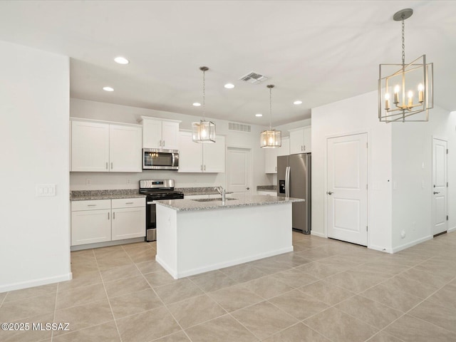 kitchen featuring visible vents, a center island with sink, white cabinetry, and stainless steel appliances