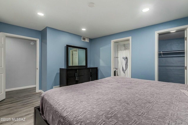 bedroom featuring hardwood / wood-style floors and a closet