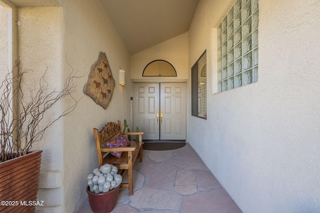 view of exterior entry with stucco siding