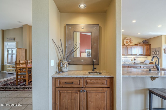 interior space with recessed lighting, light tile patterned flooring, and a sink