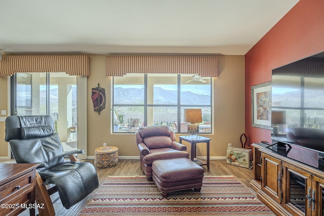 living area featuring baseboards and wood finished floors