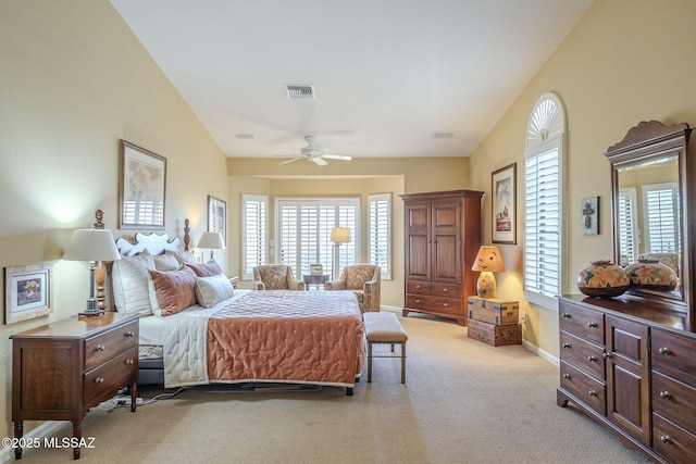 bedroom featuring lofted ceiling, light colored carpet, visible vents, ceiling fan, and baseboards