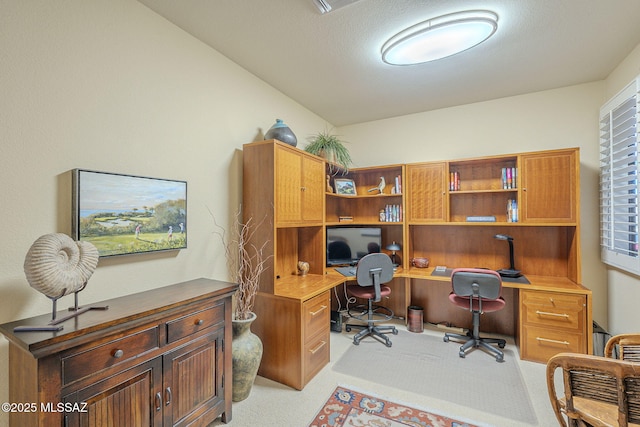 office space featuring built in desk and light colored carpet