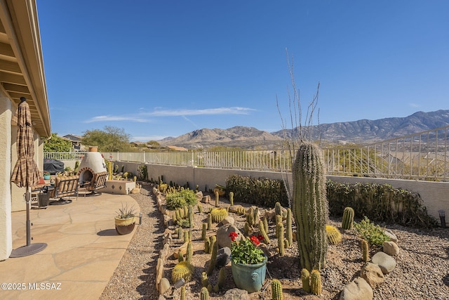 view of patio featuring a fenced backyard and a mountain view