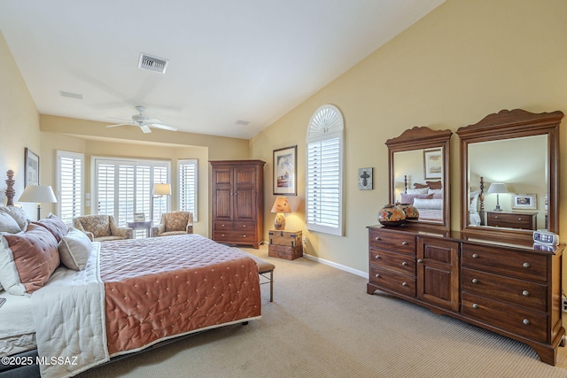 carpeted bedroom featuring lofted ceiling, visible vents, ceiling fan, and baseboards