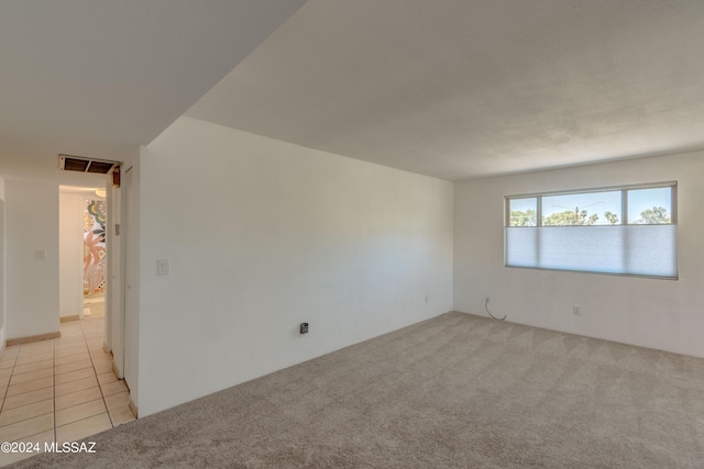 unfurnished room featuring light colored carpet