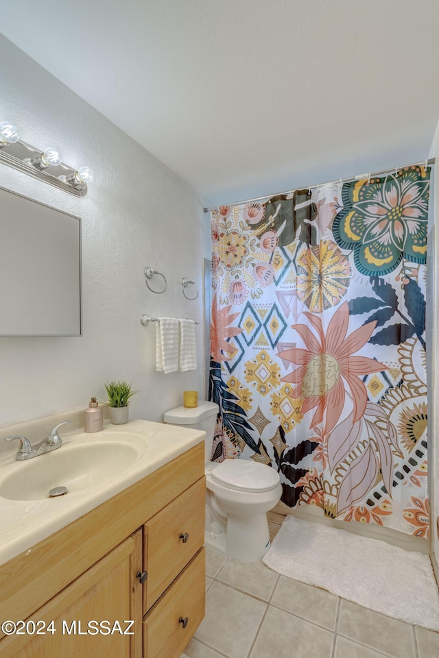 bathroom featuring vanity, a shower with shower curtain, tile patterned floors, and toilet