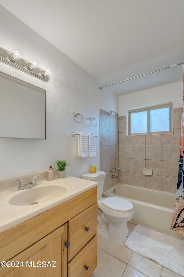 full bathroom featuring vanity, tile patterned floors, toilet, and shower / bath combo with shower curtain