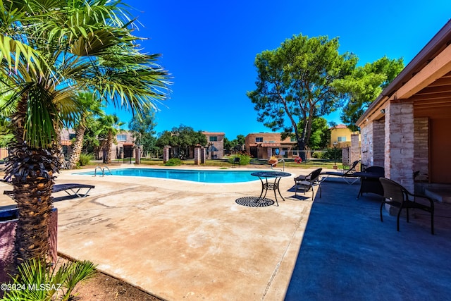 view of swimming pool with a patio area