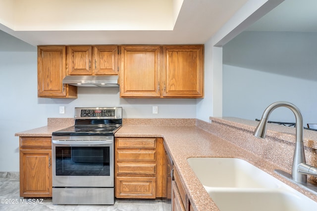 kitchen with brown cabinetry, electric stove, light countertops, under cabinet range hood, and a sink