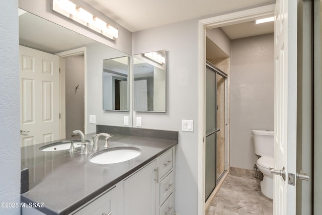 full bath with a stall shower, vanity, and toilet