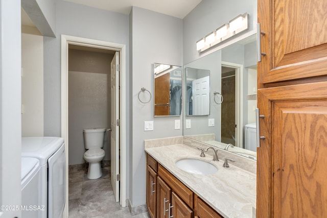 full bath with toilet, vanity, and washing machine and clothes dryer