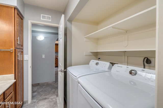 laundry room featuring laundry area, washing machine and dryer, and visible vents