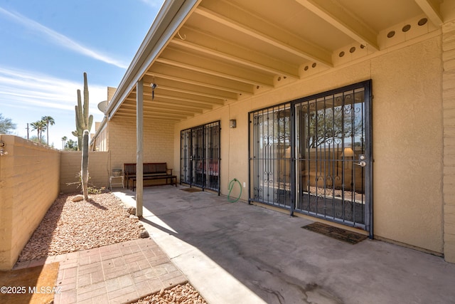 view of patio / terrace featuring fence