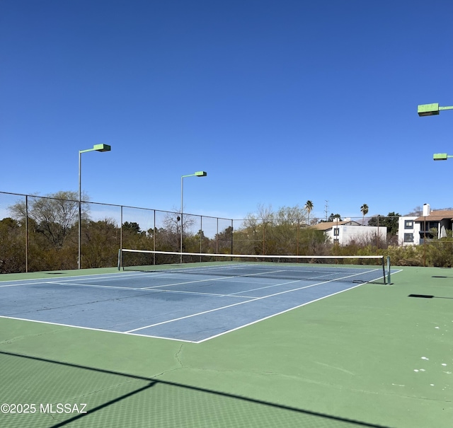 view of sport court featuring fence