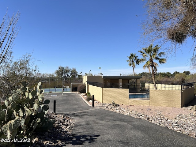 view of street featuring driveway and a gated entry