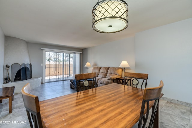 dining space featuring a large fireplace