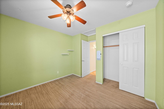 unfurnished bedroom with light carpet, ceiling fan, and a closet