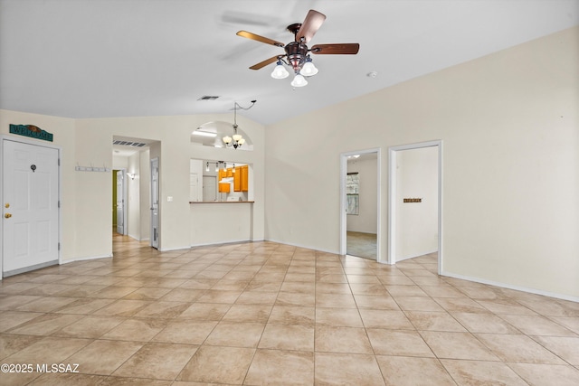 unfurnished living room with vaulted ceiling, ceiling fan with notable chandelier, and light tile patterned floors